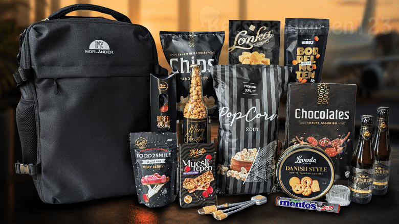 Kerstpakket met zwarte Norländer underseater, duurzame oplaadkabel, drank en diverse zoete en hartige lekkernijen.
